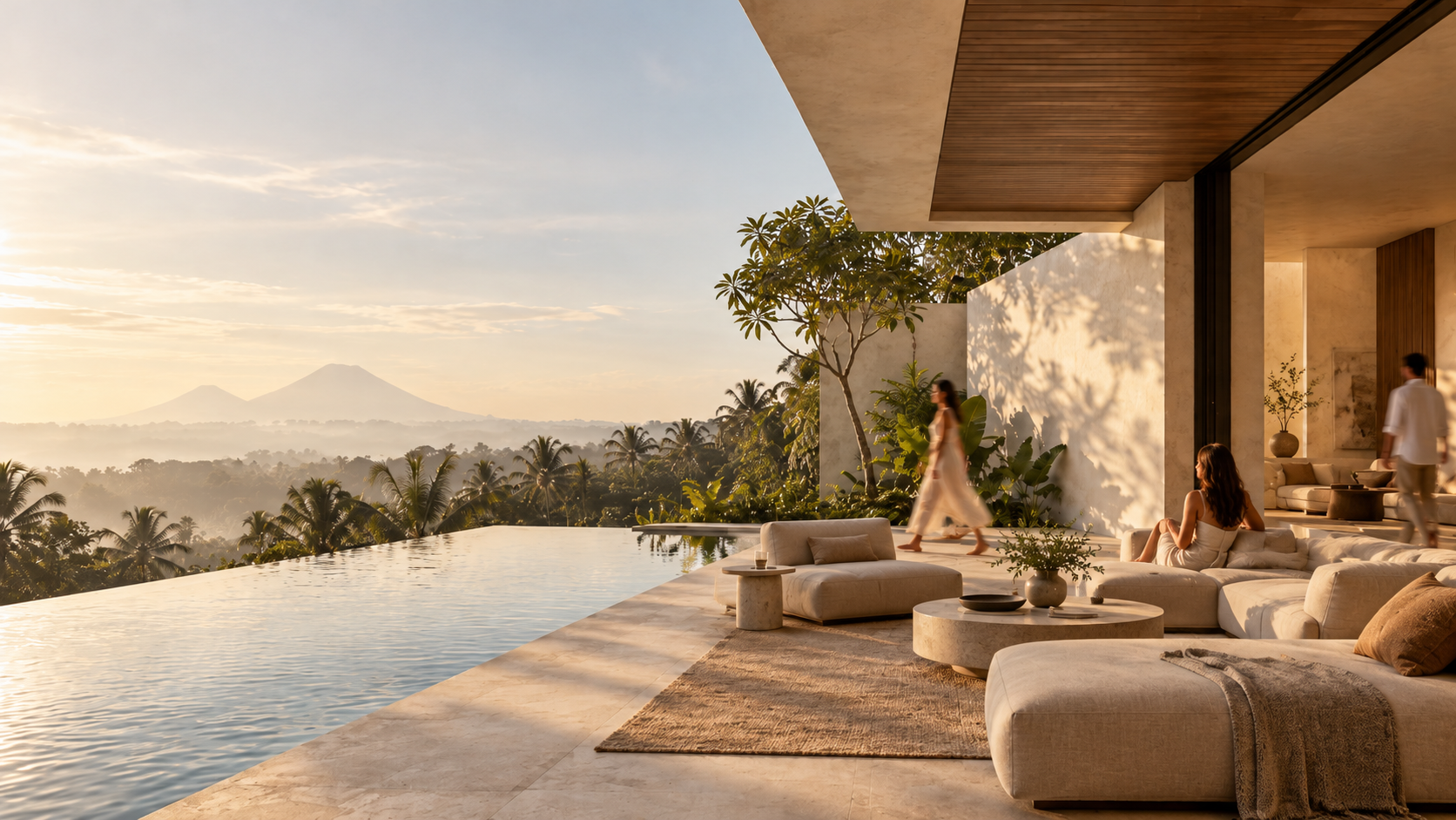 Bali villa terrace with an infinity pool overlooking the jungle and distant volcanoes at sunrise